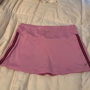Light purple tennis skirt with purple stripes on the side